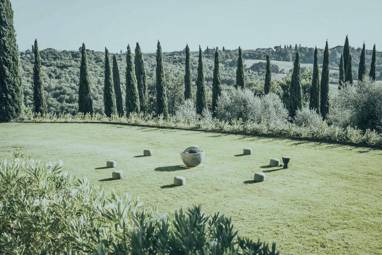 Rolling Tuscan hills with ancient olive trees and vineyards in a peaceful fallow period, embodying the cyclical rest and renewal of the land