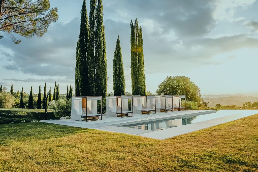 Modern garden terrace with cypress trees at One Belvedere Tuscany