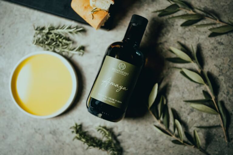 Chianti Classico extra virgin olive oil bottle with fresh olives and herbs at One Belvedere Tuscany