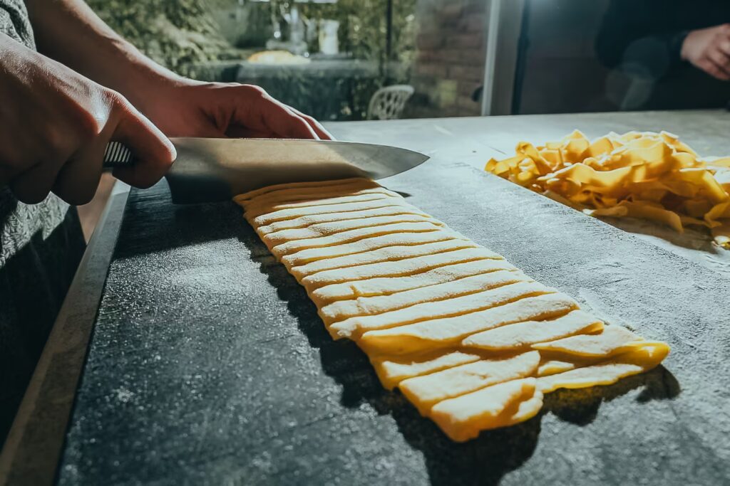 Fresh pasta preparation during a cooking class at One Belvedere Tuscany