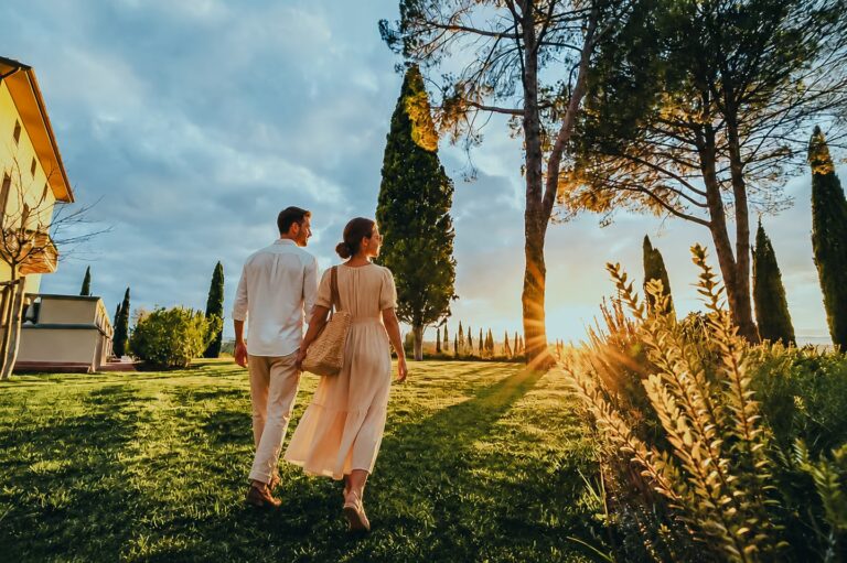 Couple enjoying quiet luxury in Italy during a sunset walk at One Belvedere Tuscany